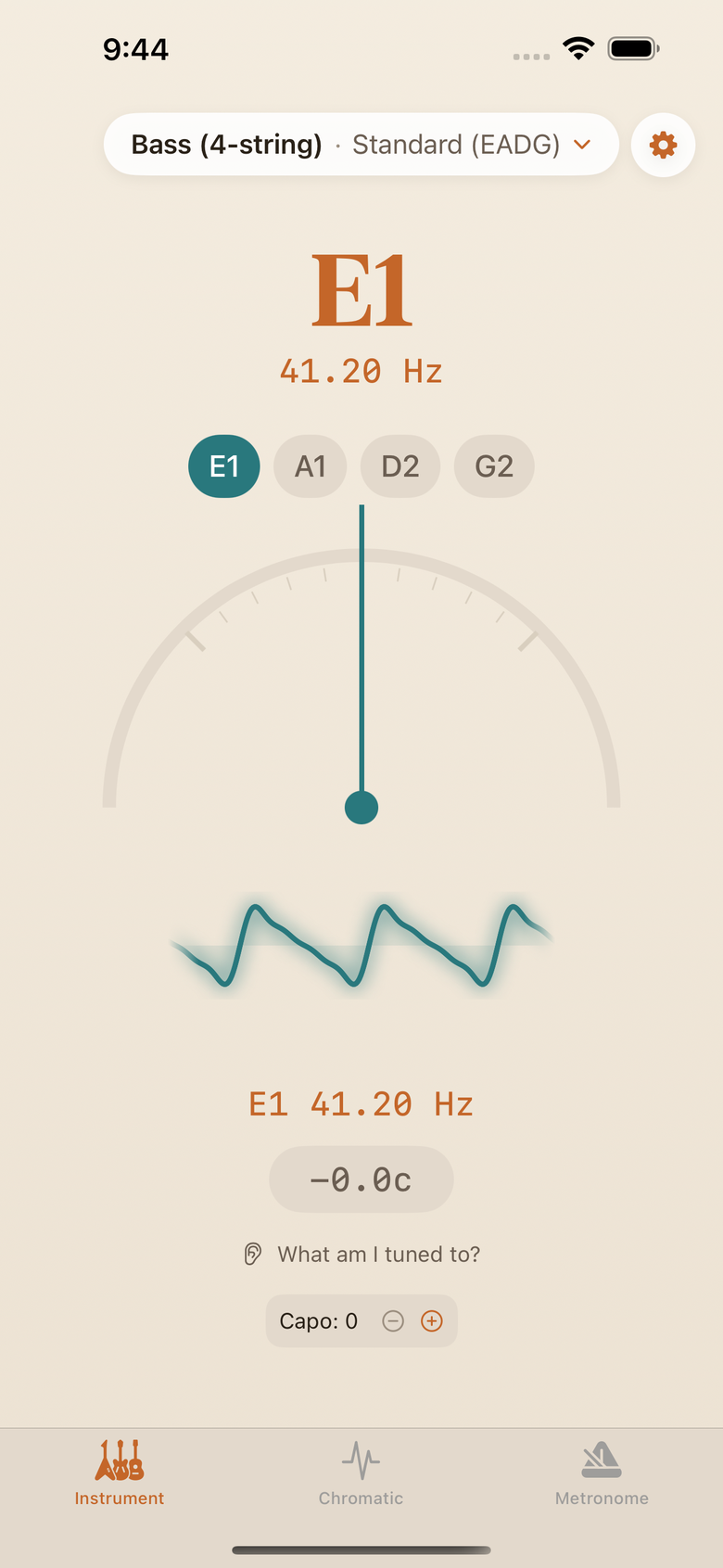 The TuneTheory instrument tuner on a four-string bass, locked on E1 at 41.20 Hz: the E1 pill and the needle are teal and the still waveform glows